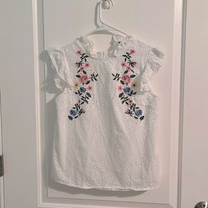 White tank top with floral detailing on front